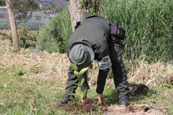 Policía del agua, en el proceso de siembra, sobre la rivera de la quebrada